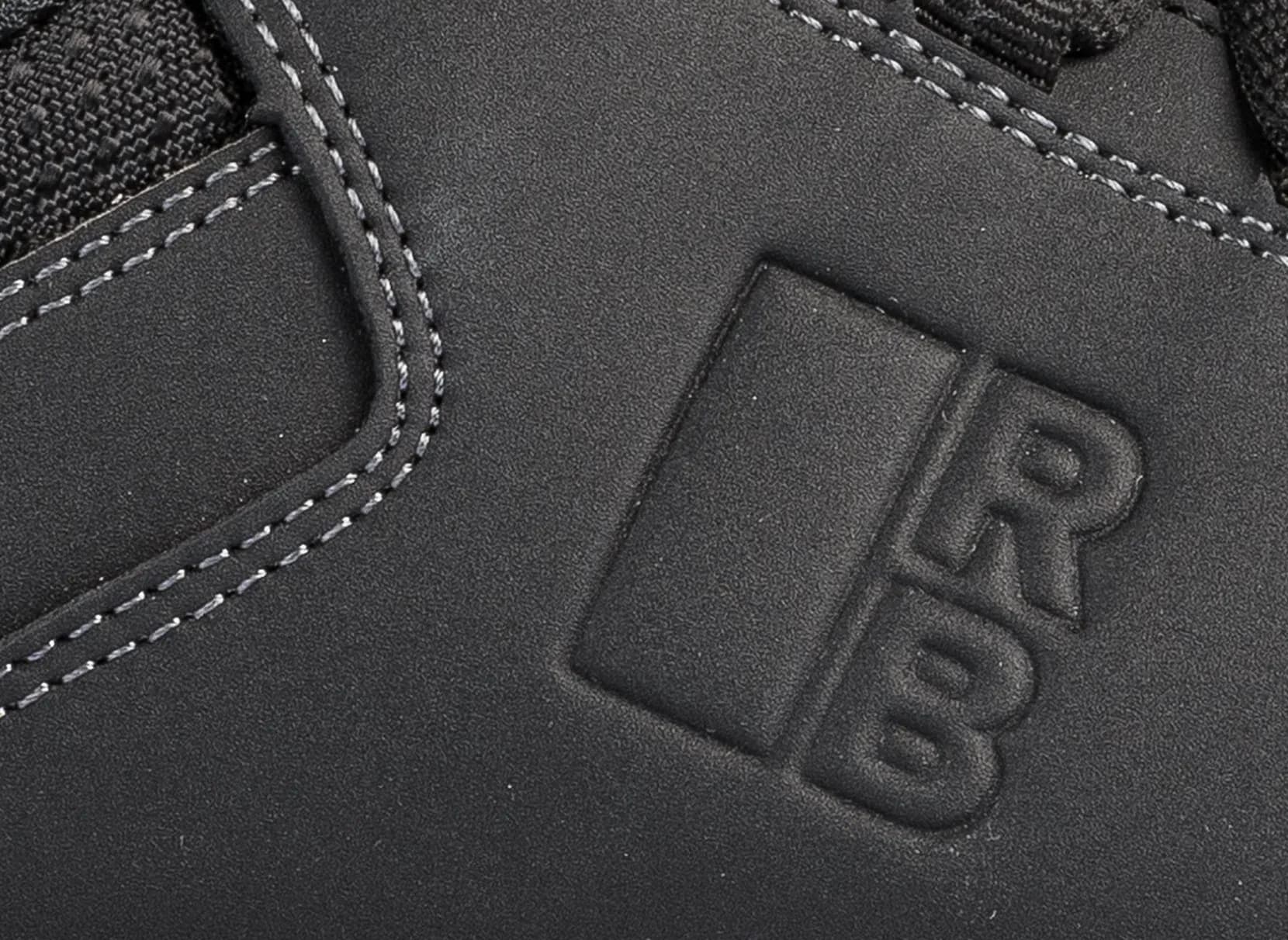 Close up leder en stiksels Redbrick Motion low veiligheidsschoen