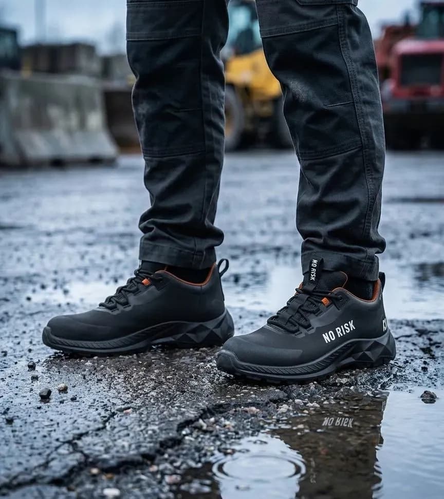 Atmospheric image of No Risk X-treme Low Black on a wet construction site
